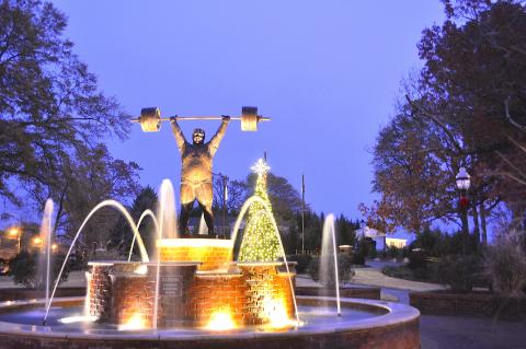 The Paul Anderson Memorial Park decorated for Christmas including the fountain in the foreground and Christmas tree in the background.