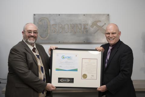 Osborne Wood marketing director Jeremy McClain (left) and company CEO Leon Osborne (right) display the Globe Award.