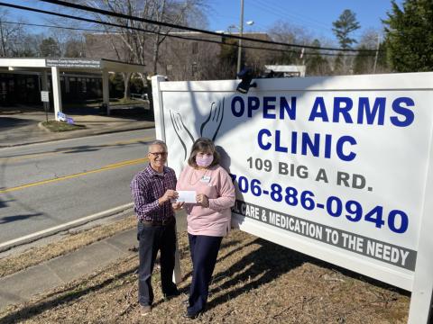 Pictured are the Rev. Andy Childs (left) presenting the grant award to Sherry Beavers, executive director of Open Arms Clinic. 