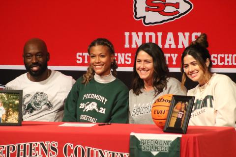 Kiki Howard and family during her signing ceremony 