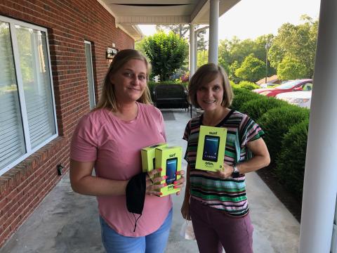 Michelle Sheriff (left) donated three laptop computers to Dr. Cynthia Shephed (right) and the cancer treatment center on Falls Road.