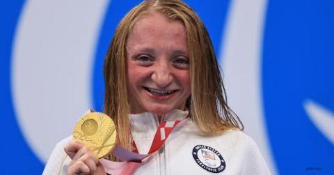 McKenzie Coan shows off the gold medal she won Sunday in the 400 meter freestyle event of the 2020 Paralympic Games in Tokyo.