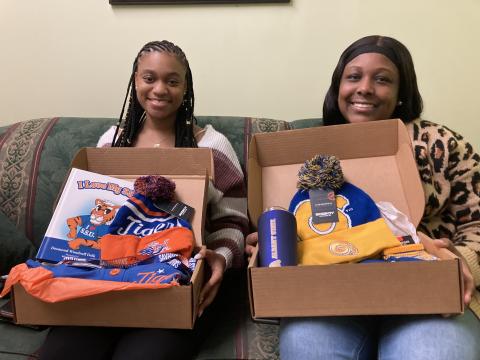 Jaylee Scott (left) and  Shakira Howard show off the contents of their College Care boxes.