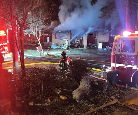 Firefighters struggle to contain a fully-involved fire at the corner of Pond and Elbertson streets.