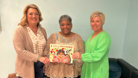Stephens County Farm Bureau (SCFB) Women’s Committee chair Sonya Stovall (left) and Hart EMC public relations director, Angie Brown (right) recently presented a copy of the children’s ag book I Love Strawberries to Shantelle Grant (center), for the Toccoa-