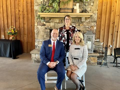 Pam Hill (seated, right) recently received the Pioneer in Education Award. At rear is school superintendent Dr. Connie Franklin. 
