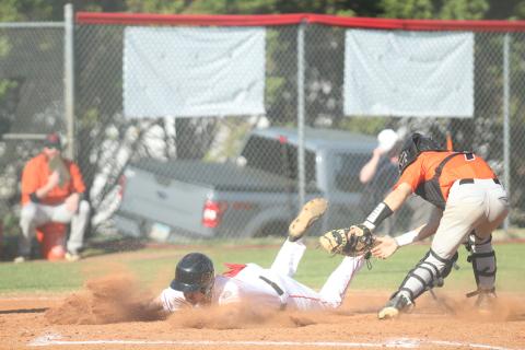Senior Ethan Smith slides into a base during one of the Indians’ baseball games last week.