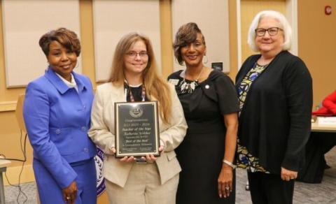 Katherine Wilcher (holding certificate)  was named Teacher of the Year by the Georgia Department of Juvenile Justice.