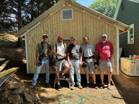 Open Arms Clinic has expanded its meidcal equipment storage shed with the held of (pictured left to right) Shannon Wigley, Tim Wilmot, Bill Stephens, Frank Moore, and Danny Yearwood.