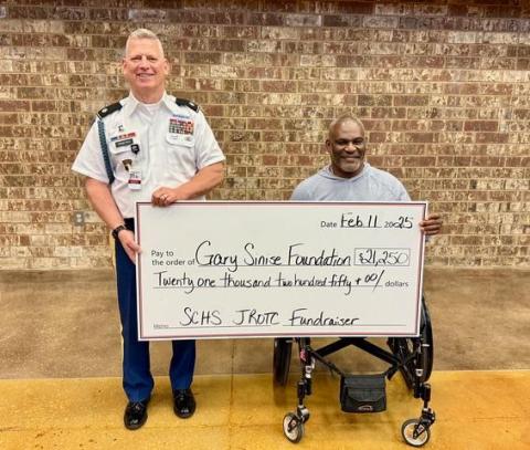 JROTC senior instructor LTC (Ret) David Priatko presented a $21,250 check to his West Point classmate and Gary Sinise Foundation board member Col. (Ret) Greg Gadson at the SCHS African American History Program.