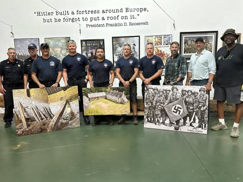 A historic beam from Normandy was given to the Currahee Military Museum on Wednesday, July 9, by Three Forks Wood Reclamation. Pictured are Toccoa Fire Department Chief Jeff Haslup, Assistant Chief Frankie Deitz, Lt. Cale Cobb, firefighter Zac Knell, firefighter Javier Perez-Cristobal, ladder engineer Stacy Lewallen, and Capt. Jonathan Jordan alongside Christian Knutzen and Christopher Kelley of Three Forks Reclamation. Submitted photo