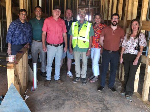 Residential development property owners recently toured and updated the status on their projects. Posing for a group shot, from left to right, on Aug. 13 are owner Bobby Shah, Stephens County Development Authority board chair Brian Akin, general contractor Ashley Hill, owner Jeremy Arrowood, construction manager Mark Gauthier, Chamber president Julie Paysen, county administrator Christian Hamilton, and Stephens County Development Authority CEO Brittany Ivey.  J. Todd Truelove/The Toccoa Record