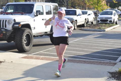 On Saturday morning, Oct. 18, the Tugalo Greenspace in downtown Toccoa was the site of a 5K race organized by Deidra Scott, of the CUREageoUS Crew, and Open Arms Clinic to raise awareness about breast cancer. Other local organizations, such as Currahee Movement Collective, participated in the event. Approaching the finish line here with a big smile and a thumbs up is Savannah Rothstein.
