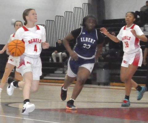 Ella Fletcher (4), left, drives to the hoop against Elbert.