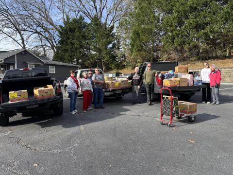 Open Arms clinic held a food drive last week that resulted in 60 boxes of food being given to families in need in Stephens County. Helping with the event were North Georgia Credit Union Vice President of Credit Administration Sonya Speed, Open Arms clinic executive director Sherry Beavers, Open Arms Marketing Director Vanessa Smith, volunteer Sam Raab, volunteer George Beavers, volunteer Alan Christ, Arwen Britton, and Open Arms Clinic board member DeLisa Christ.