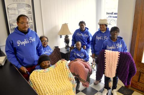 Supporters and members of the People’s First organization display some of the lap blankets made by Lanore Moore. They include (not in order) Caroline Roebuck, Dorothy Wiley, Shyresia Wiley, Tamepriacus Reese, Laura Roy, Justin Richie and Jeraldine Hayes. The blankets will be distributed to sick and elderly residents of Stephens County.