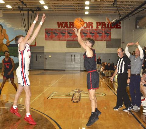 Not even the outstretched arms of a West-Oak defender and the Warrior coach could stop this three-point shot by Stephens County Colson Ivey.