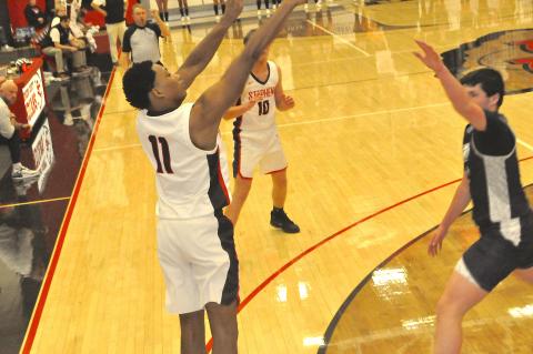 Ahmad Ivey of the Stephens County Indians launches a long range jump shot.
