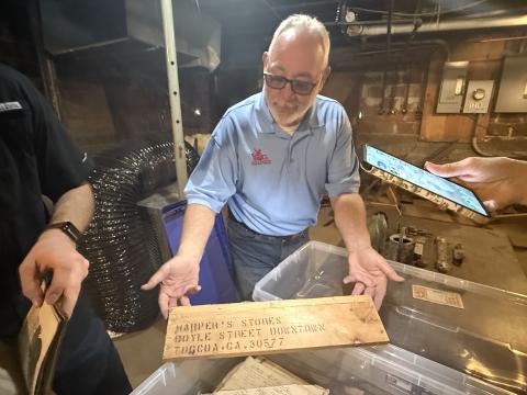 Russell Williams, of RG Williams Construction in Toccoa, shows off a piece of history he found in the old Harper's Five and 10 Cent Store.
