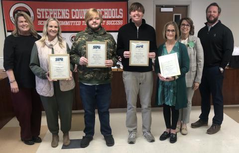 On Tuesday night, March 17, the Stephens County Board of Education honored the high school’s two STAR students and teachers.The STAR students are Logan Shirley and Landon Powell, while the STAR teachers are Kasey Ivey and Lynne Fisher. Shirley and Powell got the same SAT score. They were joined by, from left to right, Toccoa-Stephens County Chamber of Commerce President Julie Paysen, superintendent Connie Franklin, and Board of Education chair Tripp Arrowood.
