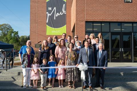 The Ivester family poses for a ribbon-cutting photo with NGTC President John Wilkinson and TCSG Commissioner Greg Dozier.