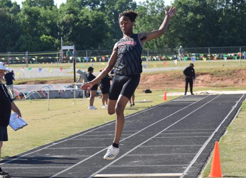Yasir Myles makes a leap during a long jump event at a regional track meet on Saturday.