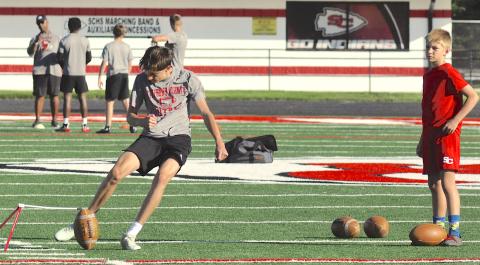 Placekicker Bo Blasingame practices kicking field goals.