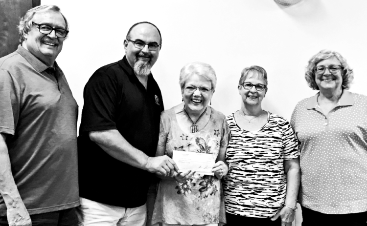 Brian Russell presents a $4,500 check