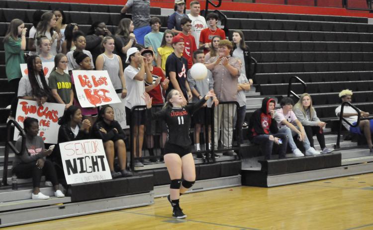 Lydia Cornelius serves during senior night