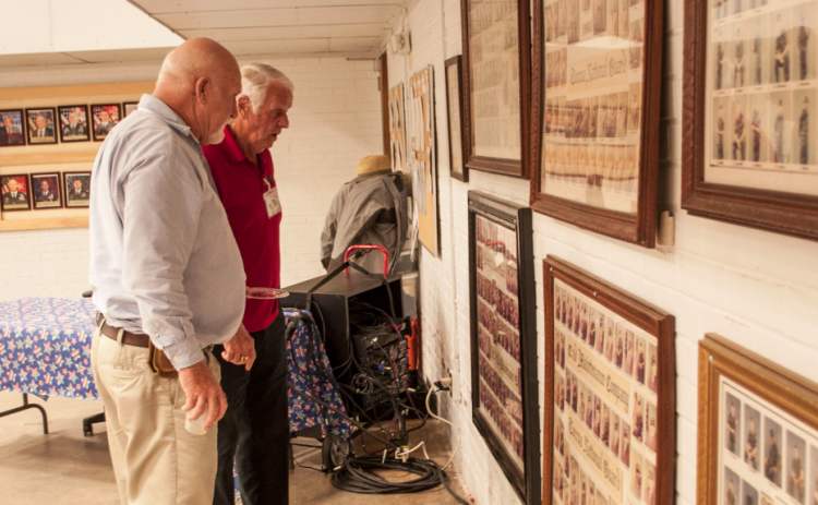‘Old Guard’ members Nicky Willis and Benny Cheek check the National Guard photos from the 1980s.