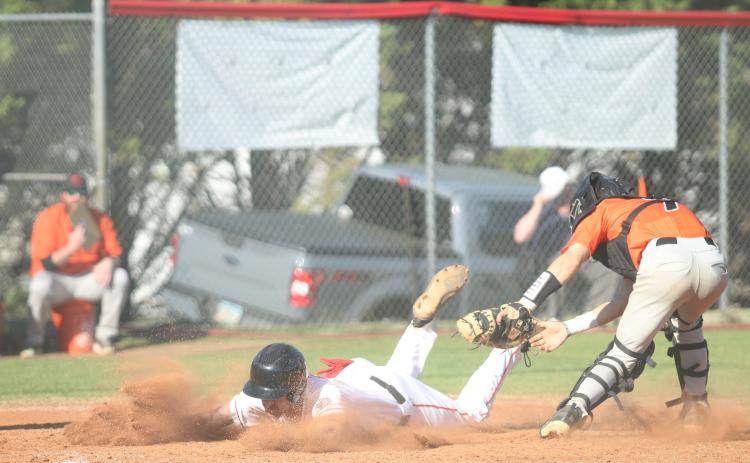 Senior Ethan Smith slides into a base during one of the Indians’ baseball games last week.