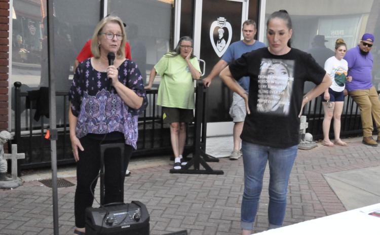 Kathy Whitmire, left, executive director for the Hope for a Drug Free Stephens oganization, and guest speaker Julie Russell, right, led a drug overdose awareness event on Thursday, Aug. 29, in downtown Toccoa.