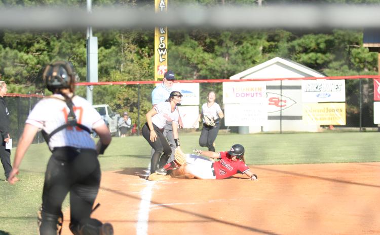 Senior Carson Stowe sliding into third during the first game in the Hart double header last week.