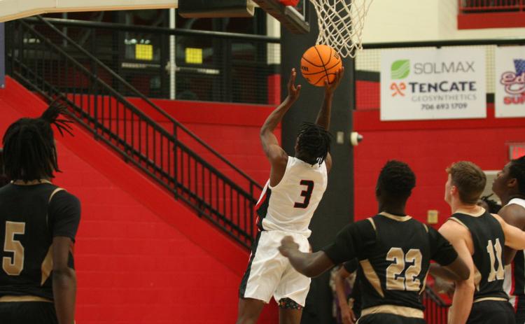CJ Harbin jumps to put the ball through the hoop in a recent game at Currahee Arena.