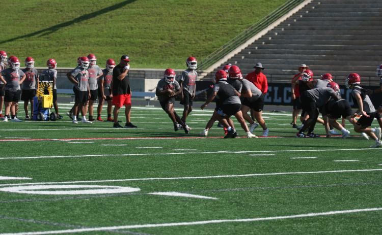 The Indians high school football team is hard at work finishing off the month of June practices this week before enjoying an off week next week. The Indians will resume practice on July 7. Pictured below are the Indians running through drills during their early morning practice. They will start workouts in full pads in July. Photo by Laura Shaw.