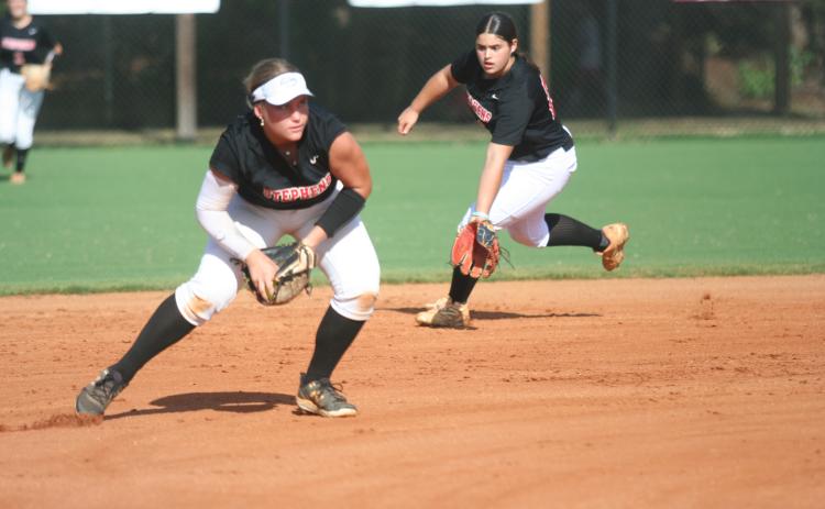Nyleigh Hutto fields a ball on the mound while Alana Thurmond backs her up. Laura Shaw/The Toccoa Record