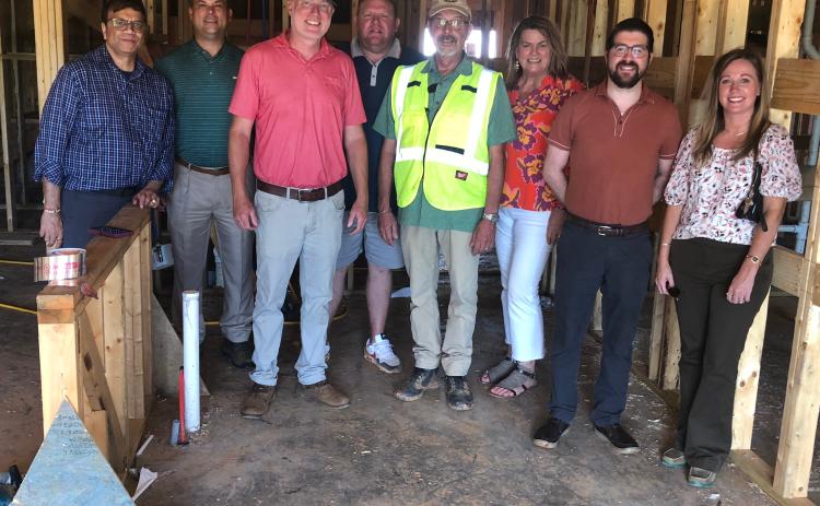 Residential development property owners recently toured and updated the status on their projects. Posing for a group shot, from left to right, on Aug. 13 are owner Bobby Shah, Stephens County Development Authority board chair Brian Akin, general contractor Ashley Hill, owner Jeremy Arrowood, construction manager Mark Gauthier, Chamber president Julie Paysen, county administrator Christian Hamilton, and Stephens County Development Authority CEO Brittany Ivey.  J. Todd Truelove/The Toccoa Record