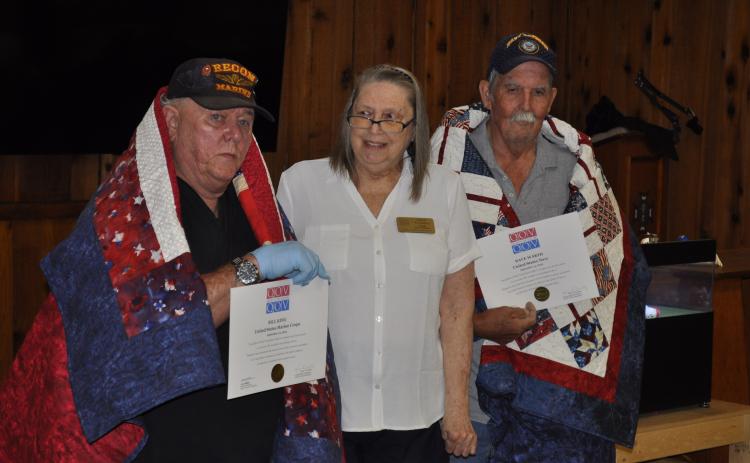 U.S. Marines veteran Bill King, left, and U.S. Navy veteran Dave Warth, right, were honored with Quilts of Valor during Bingo at the VFW headquarters in Toccoa on Monday night as part of a celebration of VFW Post 4346’s 80th anniversary. Karen Trombley, state coordinator for the Quilts of Valor Foundation, presented the quilts. Michael O'Hearn/The Toccoa Record