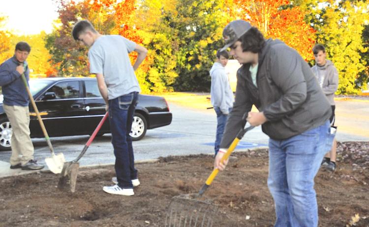 Camden Gibbs joined other Stephens County High School agricultural education students in preparing a monarch butterfly garden spot at the Toccoa-Stephens County Chamber of Commerce.