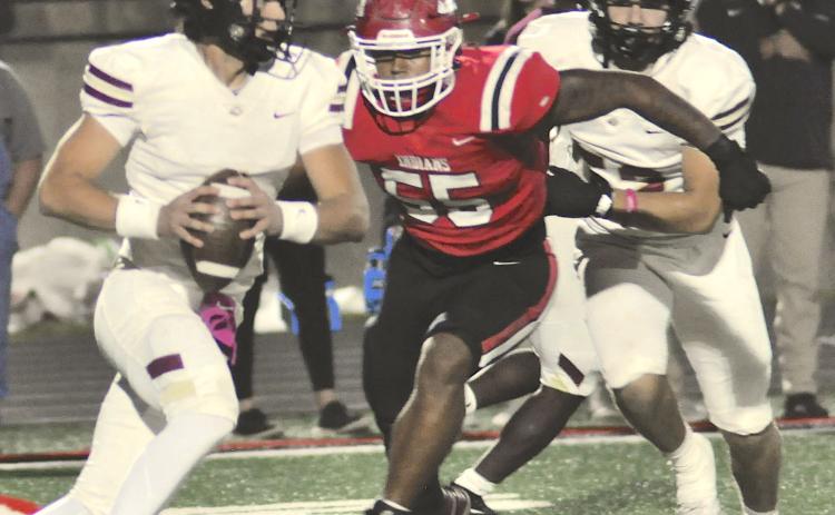 Kymani Colbert (55) puts pressure on the Hebron Christian quarterback in last Friday’s region game.
