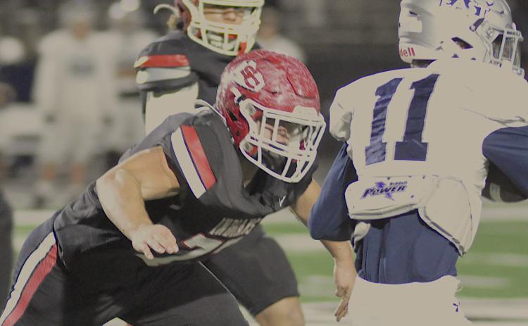 Indian offensive lineman Conner Holtzclaw (77) has an East Jackson player squarely in his target area.