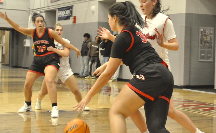 Stephens County’s Aleah Curry (30) drives to the basket as teammate Ivey Jackson (32) manuevers for the ball.