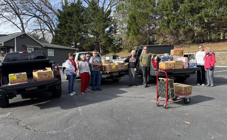 Open Arms clinic held a food drive last week that resulted in 60 boxes of food being given to families in need in Stephens County. Helping with the event were North Georgia Credit Union Vice President of Credit Administration Sonya Speed, Open Arms clinic executive director Sherry Beavers, Open Arms Marketing Director Vanessa Smith, volunteer Sam Raab, volunteer George Beavers, volunteer Alan Christ, Arwen Britton, and Open Arms Clinic board member DeLisa Christ.