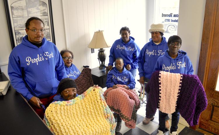 Supporters and members of the People’s First organization display some of the lap blankets made by Lanore Moore. They include (not in order) Caroline Roebuck, Dorothy Wiley, Shyresia Wiley, Tamepriacus Reese, Laura Roy, Justin Richie and Jeraldine Hayes. The blankets will be distributed to sick and elderly residents of Stephens County.
