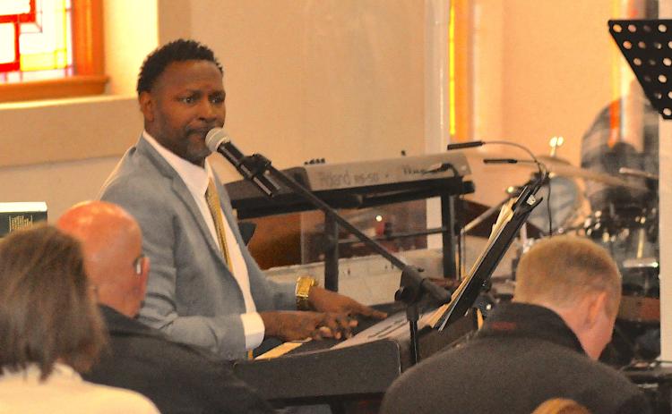 Trinity CME Church Elder Charles Thompson leads the congregation at a Dr. Martin Luther King, Jr., celebration on Monday, Jan. 19, in song and worship.