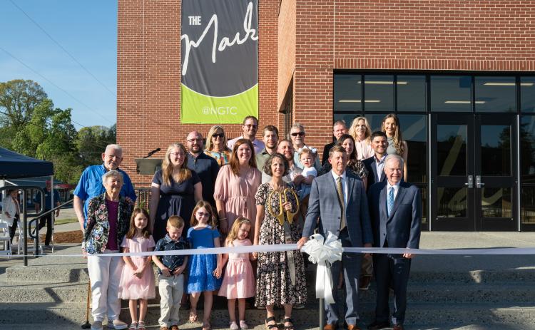 The Ivester family poses for a ribbon-cutting photo with NGTC President John Wilkinson and TCSG Commissioner Greg Dozier.