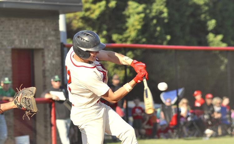 Branson Stowe is about to make contact with the ball.