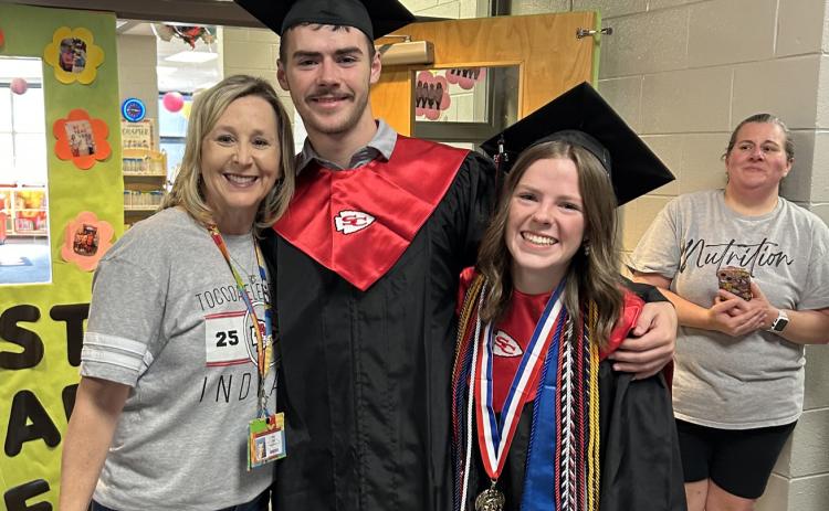 Ethan and Allyson Green, who are graduating from Stephens County High School tomorrow night, embrace their aunt, Toccoa Elementary School media specialist Amy Lee, during the traditional Senior Walk at the elementary school last week.