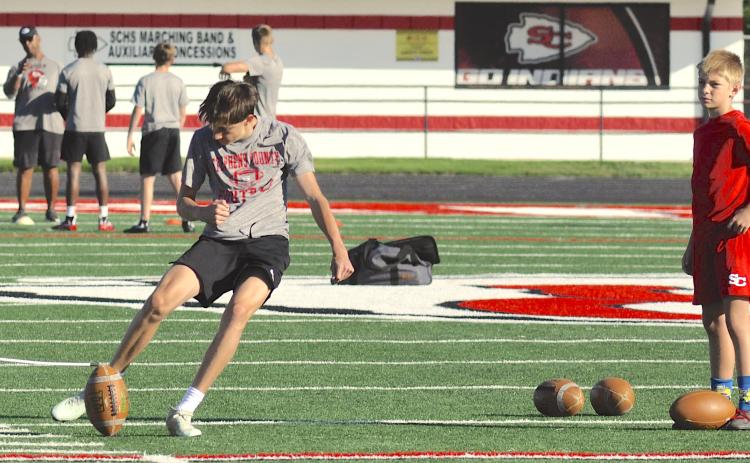 Placekicker Bo Blasingame practices kicking field goals.