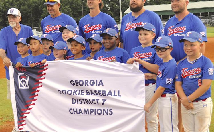 Toccoa Rookie League all-stars and their coaches celebrated the District 7 championship in Hartwell Monday night. Team members are (not in order) Kingston Schultz, Chase Hickman, Huck Thomas, Easton Koppin, Rex Youngblood, Grayson Turk, William Stein, Elijah Newkirk, Cohen Gastley, Jasper Ebadolahi, Emerson Edge and Cooper Teater. In the back are Toccoa Little League president Doug McCollum and all-star coaches Michael Koppin, Luke Youngblood, Kaleb Turk and Zac Stein.